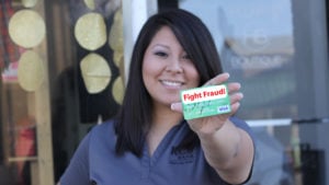 Girl holding credit card that reads fight fraud