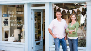 Business couple in front of organic store