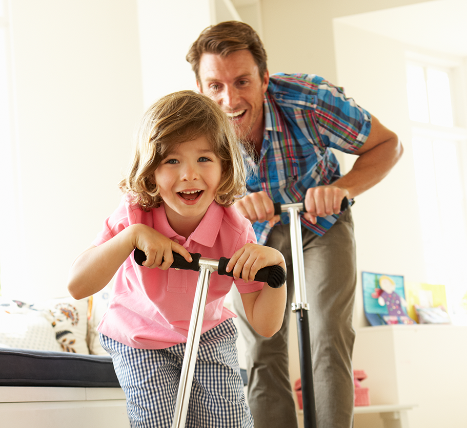 father and child riding scooters