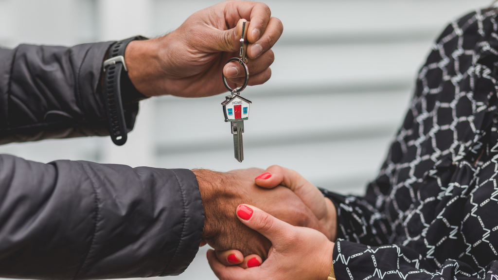 Person handing over house keys