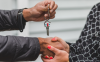 Person handing over house keys