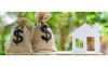 Money bags and a house on a scale