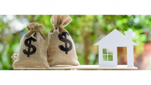 Money bags and a house on a scale