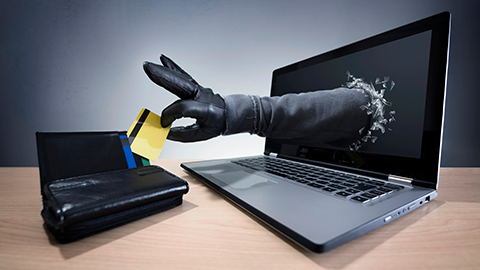 Electronic fraud. Hand stealing credit card.