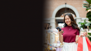 Woman looking at phone smiling
