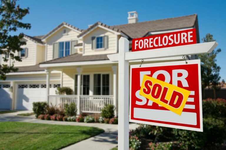 SOLD sign in front of house
