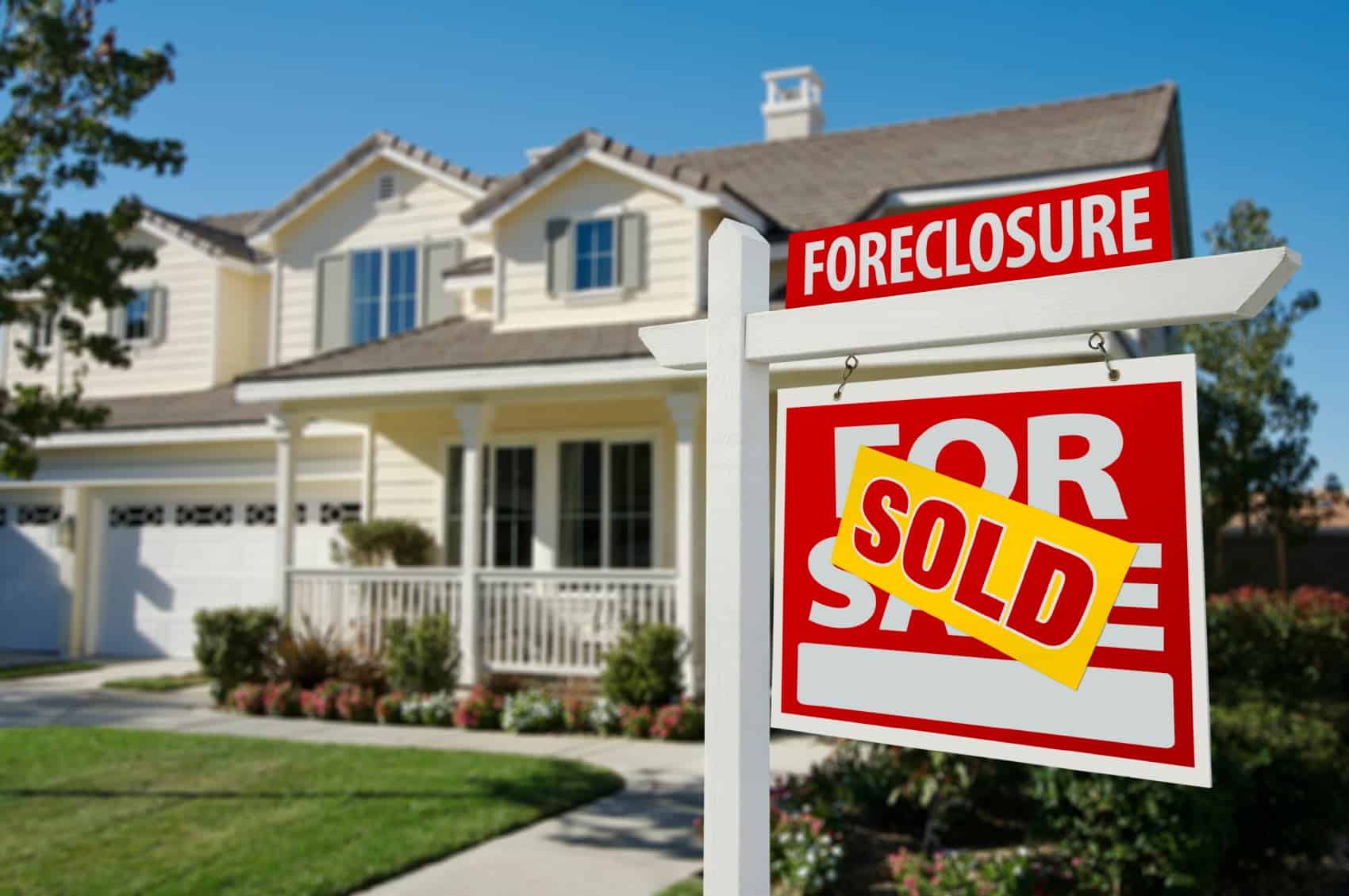 SOLD sign in front of house
