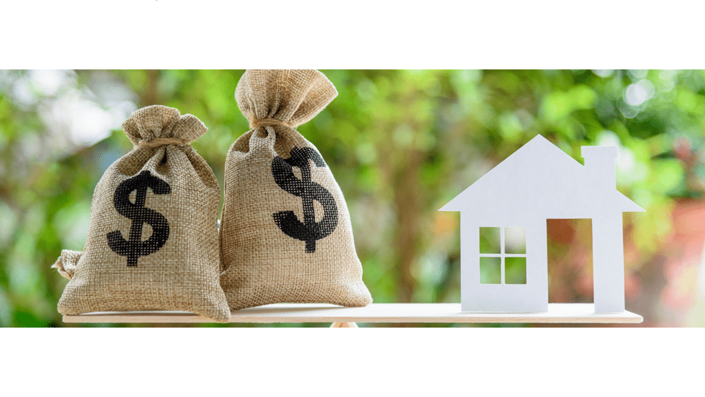 Money bags and a house on a scale